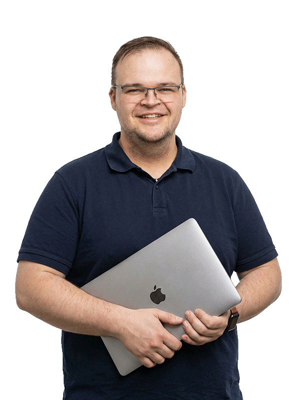 Daniel Orosz, founder of OROS Agency, holding a laptop